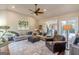 Comfortable living room featuring a ceiling fan, plush seating, and access to the backyard at 214 Palette Ln, Peachtree City, GA 30269