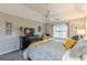 Beautiful primary suite featuring a ceiling fan, TV, walk-in closet and a sitting area near a large window at 214 Palette Ln, Peachtree City, GA 30269