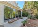 Cozy patio with brick accents and large sliding glass doors leading to a lush, landscaped yard and garden at 214 Palette Ln, Peachtree City, GA 30269