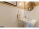 Close up view of this powder room showing the pedestal sink and wainscoting at 214 Palette Ln, Peachtree City, GA 30269