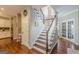 Elegant stairway featuring white railings, hardwood steps, and natural light, enhancing the home's entry at 214 Palette Ln, Peachtree City, GA 30269