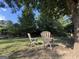 Inviting backyard sitting area with mature shade trees perfect for relaxation at 610 Tower Rd, Peachtree City, GA 30269