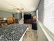 This bedroom is filled with natural light and features wood flooring and furniture at 610 Tower Rd, Peachtree City, GA 30269