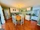 A bright dining area adjacent to the kitchen, featuring a wooden table, white chairs and ample natural light at 610 Tower Rd, Peachtree City, GA 30269