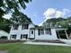 Charming two-story home with white siding, black shutters, and a well-maintained front lawn at 610 Tower Rd, Peachtree City, GA 30269