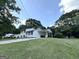 A well-manicured lawn enhances the curb appeal of this lovely two-story home with covered parking at 610 Tower Rd, Peachtree City, GA 30269