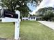 Well-manicured lawn leading to a two-story home with a convenient carport and a classic mailbox at 610 Tower Rd, Peachtree City, GA 30269