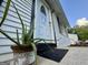 Close-up of a welcoming front door with decorative potted plant and stylish accents at 610 Tower Rd, Peachtree City, GA 30269