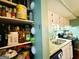 Pantry view showcasing well-stocked shelves adjacent to the kitchen with white cabinets and granite counters at 610 Tower Rd, Peachtree City, GA 30269