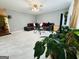 Inviting living room featuring neutral walls, tile floors, a comfortable sofa, and a glass coffee table at 610 Tower Rd, Peachtree City, GA 30269