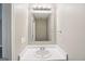 Clean bathroom featuring a single sink, modern fixtures, a large mirror, and light neutral walls at 1159 Smith Sw St, Atlanta, GA 30310