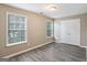 Bedroom with neutral walls, modern flooring, natural light, and a closet at 1159 Smith Sw St, Atlanta, GA 30310
