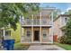 Charming two-story home with double porches and yellow siding, creating inviting curb appeal at 1159 Smith Sw St, Atlanta, GA 30310