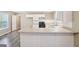 Bright kitchen features white cabinets, tile backsplash, stainless steel appliances, and durable modern flooring at 1159 Smith Sw St, Atlanta, GA 30310