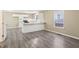 Bright kitchen features white cabinets, tile backsplash, stainless steel appliances, and durable modern flooring at 1159 Smith Sw St, Atlanta, GA 30310