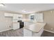 Bright kitchen features white cabinets, tile backsplash, stainless steel appliances, and durable modern flooring at 1159 Smith Sw St, Atlanta, GA 30310