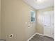 A dedicated laundry room featuring a window, modern flooring, and utility connections at 1159 Smith Sw St, Atlanta, GA 30310