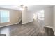 Spacious living room with sleek floors, ceiling fan and open floor plan leading to the kitchen at 1159 Smith Sw St, Atlanta, GA 30310