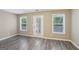 This living room features multiple windows and a door with access to the exterior at 1159 Smith Sw St, Atlanta, GA 30310
