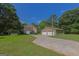 Aerial shot of the house with mature landscaping, large driveway and multi-car detached garage at 183 Inman Rd, Fayetteville, GA 30215
