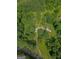 Aerial view showcases a secluded property surrounded by lush greenery and mature trees at 183 Inman Rd, Fayetteville, GA 30215