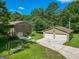 Aerial perspective of the home, showcasing its expansive grounds and multi-car detached garage at 183 Inman Rd, Fayetteville, GA 30215