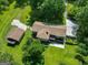 Aerial view of a home and detached garage surrounded by lush greenery and mature trees at 183 Inman Rd, Fayetteville, GA 30215