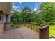 Enjoy outdoor living on this wood deck, surrounded by mature trees at 183 Inman Rd, Fayetteville, GA 30215