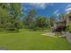 Lush backyard showcasing a blend of open lawn and mature trees, providing a private and peaceful setting at 183 Inman Rd, Fayetteville, GA 30215