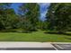 Expansive backyard with mature trees and green grass, offering a serene and private outdoor space at 183 Inman Rd, Fayetteville, GA 30215
