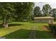 Expansive backyard featuring a lush lawn, mature trees, and a detached structure at 183 Inman Rd, Fayetteville, GA 30215