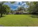 Expansive backyard showcasing a two-story home, outbuilding, and a sprawling lawn with mature trees at 183 Inman Rd, Fayetteville, GA 30215