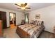 Inviting bedroom featuring a comfortable bed, soft carpet, and a bright ceiling fan light at 183 Inman Rd, Fayetteville, GA 30215