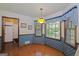 Cozy dining area featuring blue patterned walls, hardwood floors, and natural light at 183 Inman Rd, Fayetteville, GA 30215