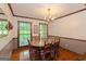 Traditional dining room with wood table, chandelier lighting, and large windows at 183 Inman Rd, Fayetteville, GA 30215