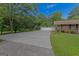 Spacious driveway leads to the garage and is bordered by a white fence at 183 Inman Rd, Fayetteville, GA 30215