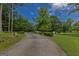 Long driveway leads to a private property surrounded by greenery at 183 Inman Rd, Fayetteville, GA 30215