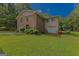 Spacious home with brick and siding, an attached garage, and a well-maintained lawn at 183 Inman Rd, Fayetteville, GA 30215