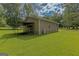 View of the exterior showing the detached garage and the nicely landscaped backyard at 183 Inman Rd, Fayetteville, GA 30215
