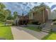 Two-story brick and vinyl home featuring a wooden deck and concrete patio, surrounded by a green lawn at 183 Inman Rd, Fayetteville, GA 30215
