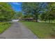 Charming brick ranch-style home with a well-manicured front lawn and mature trees at 183 Inman Rd, Fayetteville, GA 30215
