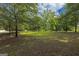 Spacious front yard with mature shade trees and manicured landscaping at 183 Inman Rd, Fayetteville, GA 30215