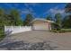 Attached garage with a large driveway and decorative white fence at 183 Inman Rd, Fayetteville, GA 30215