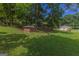 View of property featuring brick shed, house, and multi-car detached garage at 183 Inman Rd, Fayetteville, GA 30215