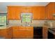 Kitchen featuring wood cabinets, granite countertops and stainless-steel dishwasher at 183 Inman Rd, Fayetteville, GA 30215