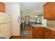 Bright kitchen showcases wood cabinetry, a refrigerator, and adjacent eat-in area at 183 Inman Rd, Fayetteville, GA 30215