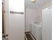 Functional laundry area featuring a washer, dryer, and storage shelves for efficient organization at 183 Inman Rd, Fayetteville, GA 30215