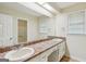Bathroom with an elongated vanity, dual sinks, and a full mirror at 5618 Shadow Rock Dr, Lithonia, GA 30058