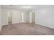Spacious carpeted bedroom with multiple doorways and neutral wall paint at 5618 Shadow Rock Dr, Lithonia, GA 30058