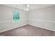 Cozy bedroom with neutral carpet, trim, and a bright window at 5618 Shadow Rock Dr, Lithonia, GA 30058